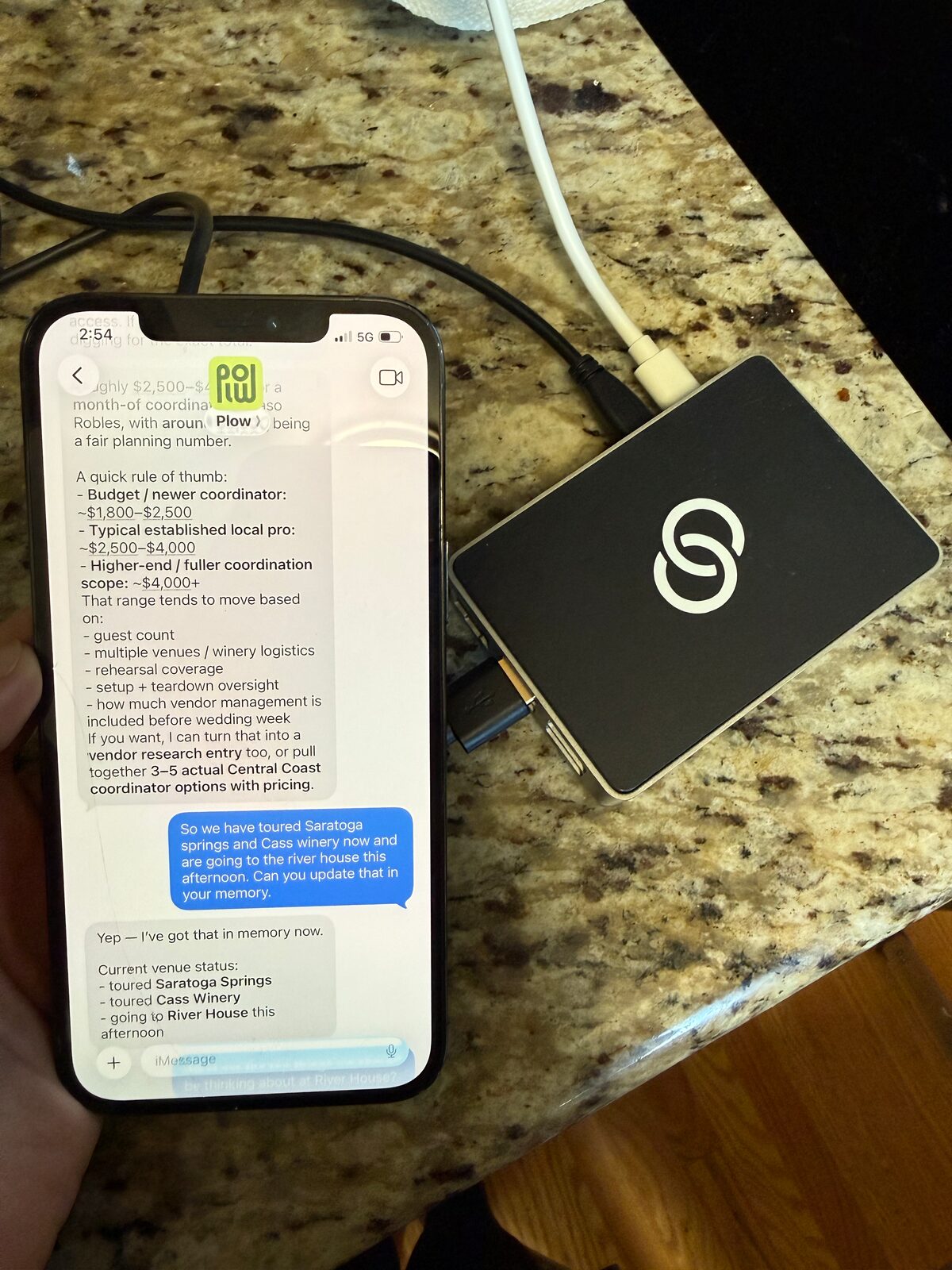 An iMessage thread with a Hermes agent shown on a device sitting on a kitchen counter.
